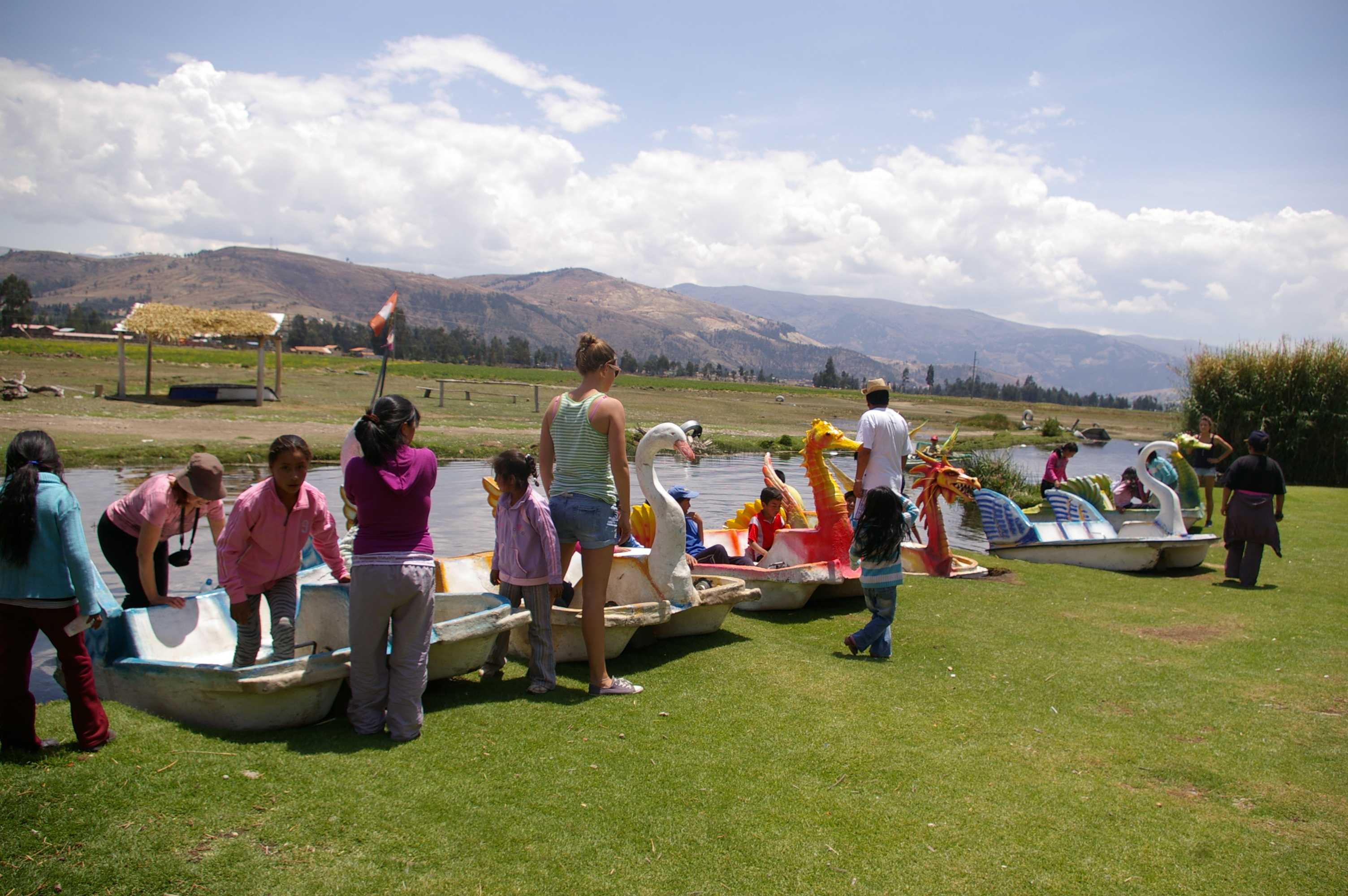 Volunteers and children at an event where they were about to go row boating.